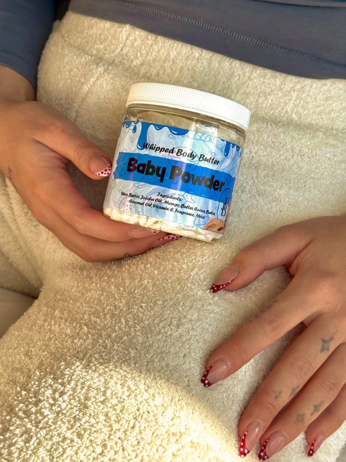 Baby Powder whipped body butter held on a towel